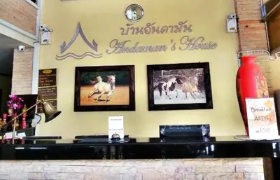 a restaurant with pictures of horses on the wall at Andaman House SHA Plus in Patong Beach