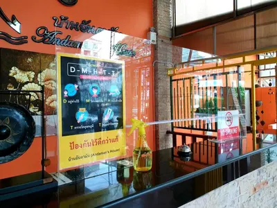 a store front with a glass counter with a sign on it at Andaman House SHA Plus in Patong Beach