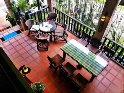 an overhead view of a patio with a table and chairs at Andaman House SHA Plus in Patong Beach