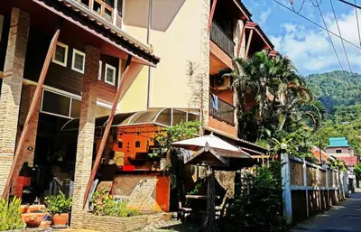 an umbrella sitting in front of a building at Andaman House SHA Plus in Patong Beach