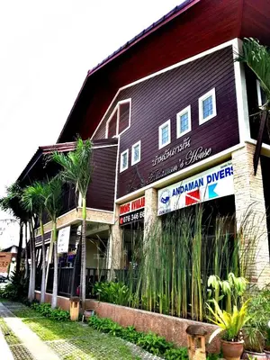 a large building with aandan dinner signs on it at Andaman House SHA Plus in Patong Beach