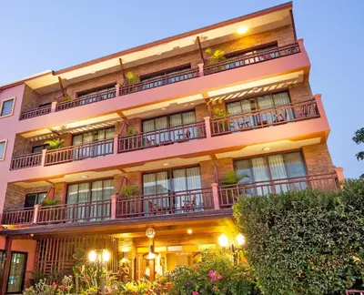 an apartment building with balconies and plants at Orchid Garden Hotel Patong in Patong Beach