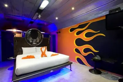 a bedroom with a bed and a wall with flames at Nicky's Handlebar in Patong Beach