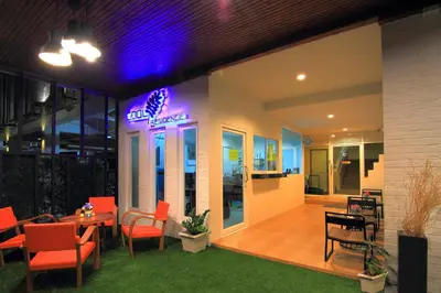 a restaurant with a neon sign on the side of a building at Cool Residence Hotel in Phuket Town