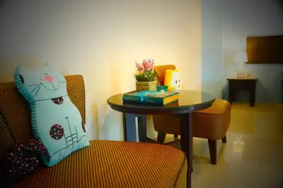 a room with a table and a chair and a table and a table at Cool Residence Hotel in Phuket Town