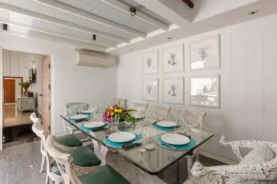 a dining room with a glass table and chairs at Kalim Beach House - Private Beach & Pool in Patong Beach