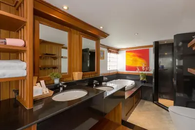 a bathroom with two sinks and a large mirror at Kalim Beach House - Private Beach & Pool in Patong Beach