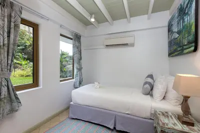 a white bedroom with a bed and a window at Kalim Beach House - Private Beach & Pool in Patong Beach