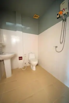 a bathroom with a toilet and a sink at Pineapple Guesthouse in Karon Beach