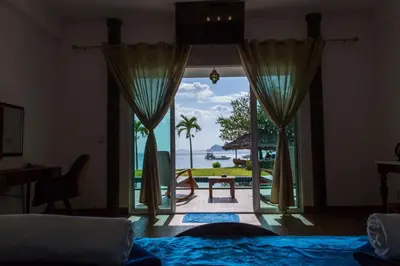 a room with a view of the ocean from a bedroom at Yao Yai Beach Resort in Ko Yao Yai