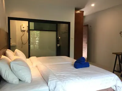 a large bed with a blue object on top of it at Anattaya Holiday Home in Ko Yao Noi