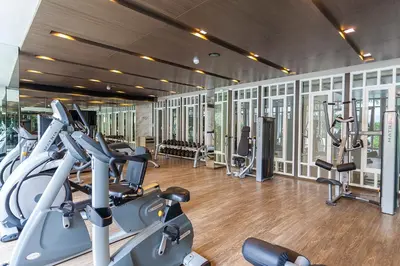 a gym with several treadmills and cardio machines at Phuket Town 1 Bedroom Condo Luxury Facilities, The Base Downtown in Phuket Town