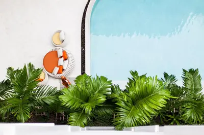 a table topped with plants and a clock withosexuals at Phuket Town 1 Bedroom Condo Luxury Facilities, The Base Downtown in Phuket Town