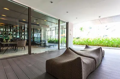a living room with a couch on a wooden floor at Phuket Town 1 Bedroom Condo Luxury Facilities, The Base Downtown in Phuket Town