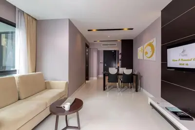 a living room with a couch and a flat screen tv at Luxury Beach Apartments by MVP in Patong Beach