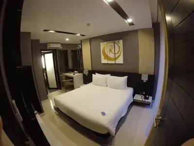 a bedroom with a large white bed in it at Luxury Beach Apartments by MVP in Patong Beach