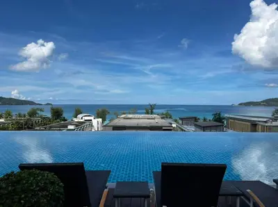 a swimming pool with a view of the ocean at Luxury Beach Apartments by MVP in Patong Beach