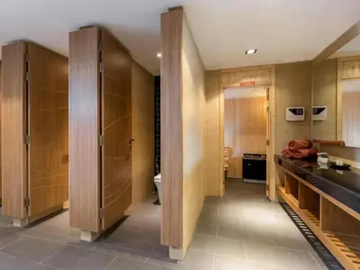 a bathroom with wooden cabinets and a sink at Luxury Beach Apartments by MVP in Patong Beach