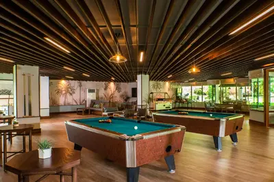 a pool room with two pool tables in it at Naithonburi Beach Resort - SHA Extra Plus in Nai Thon Beach