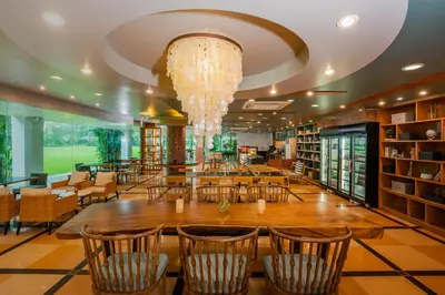 a large library with a large wooden table and chairs at Naithonburi Beach Resort - SHA Extra Plus in Nai Thon Beach