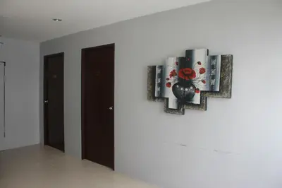 a painting on a wall in a room with doors at Holiday Home Patong in Patong Beach