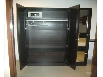a black closet with hangers and a mirror at Holiday Home Patong in Patong Beach
