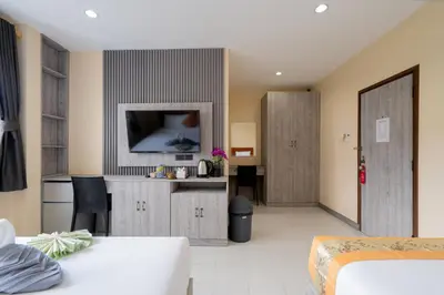 a hotel room with a bed and a tv in it at Square One Hotel Patong in Patong Beach