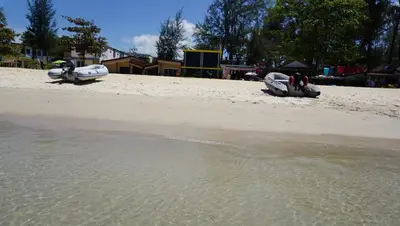 two boats sitting on the sand on a beach at TT Naiyang Beach Phuket in Nai Yang Beach