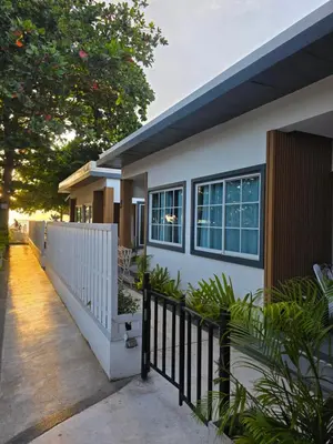 a house with a white fence and a gate at TT Naiyang Beach Phuket in Nai Yang Beach