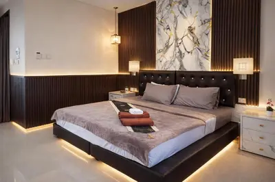 a bedroom with a large bed in a room at Happy Fish Guesthouse in Patong Beach