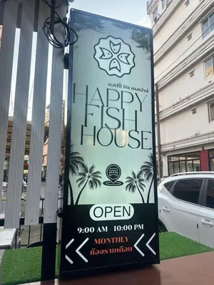 a sign for a happy fish house in front of a building at Happy Fish Guesthouse in Patong Beach