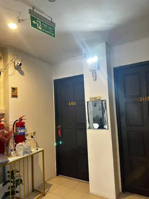 a room with two black doors and a sign on the wall at Happy Fish Guesthouse in Patong Beach