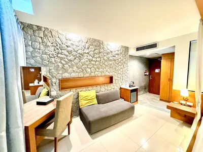 a living room with a couch and a table at De Cozé Hotel in Patong Beach