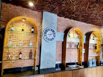 a brick wall with a clock on the wall at De Cozé Hotel in Patong Beach