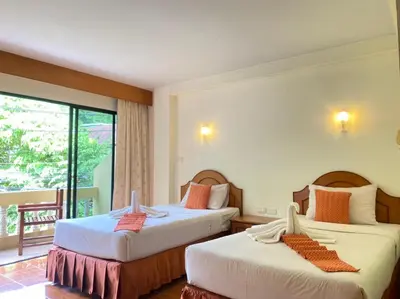 a hotel room with two beds and a balcony at Kata View Guest House in Kata Beach