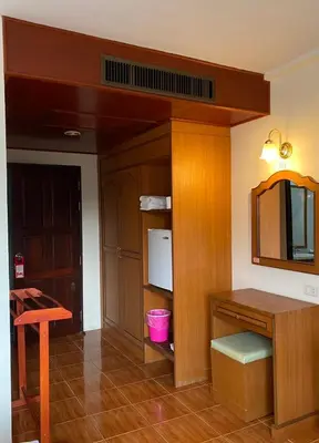 a room with a kitchen with a table and a tv at Kata View Guest House in Kata Beach