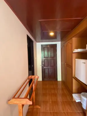 a room with a staircase and a kitchen with a door at Kata View Guest House in Kata Beach