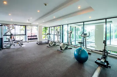 a gym with tread machines and a ball in the middle at The Unity Patong in Patong Beach