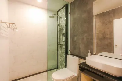 a bathroom with a sink and a toilet and a shower at The Mantra Hotel Kata Noi in Kata Beach