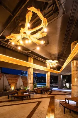 a large room with tables and a chandelier at EcoLoft Hotel - SHA Plus in Phuket Town