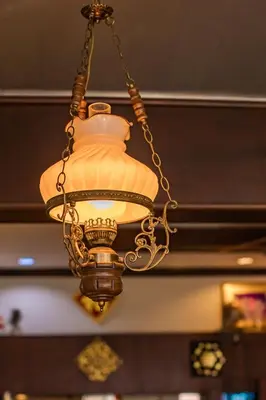 a chandelier hanging from the ceiling in a restaurant at Pro Andaman Place in Karon Beach