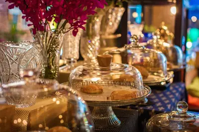 a table with plates of pastries in glass containers at Pro Andaman Place in Karon Beach