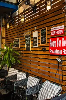 a room with chairs and signs on a wall at Pro Andaman Place in Karon Beach