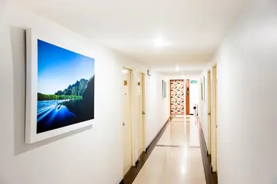 a hallway with a large painting on the wall at Crystal Inn in Phuket Town