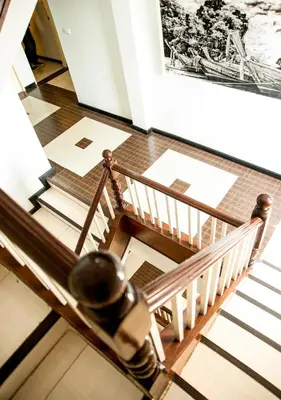a spiral staircase in a building with a picture on the wall at Crystal Inn in Phuket Town