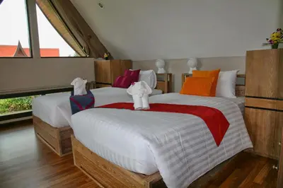 a bedroom with two beds with towels on them at Tha Lane Bay Villas in Tha Lane Bay