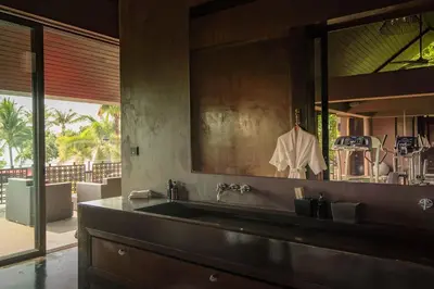 a kitchen with a sink and a large mirror at Villa Saanti in Natai Beach