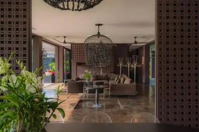 a living room with a couch and a table at Villa Saanti in Natai Beach