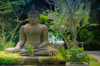 a large statue of a buddha in a garden at Villa Saanti in Natai Beach