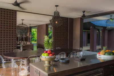 a dining room with a table with a bowl of fruit at Villa Saanti in Natai Beach